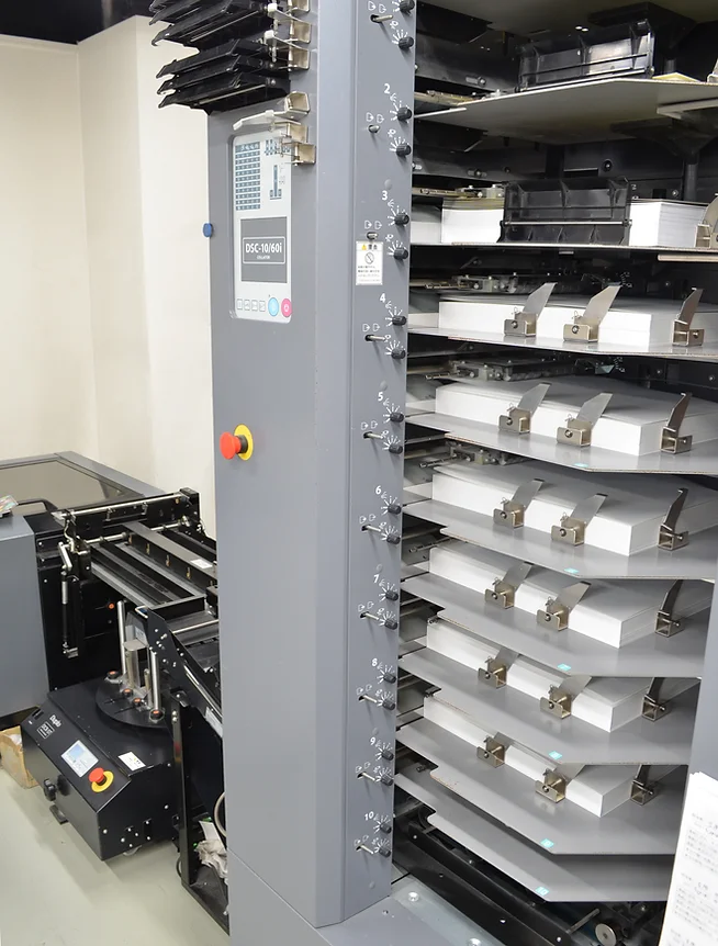 鞍掛中綴じ施本システム